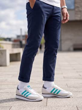 Style with navy slim-fit chinos and a crisp white polo shirt for a smart-casual look that leans into a refined motorsport aesthetic.