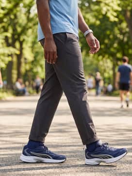 A smart-casual active style pairing straight-leg khaki chinos with a light blue linen shirt for a relaxed yet polished appearance.