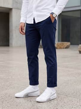 Tapered navy chinos and a white button-down shirt for a sharp, clean-cut aesthetic perfect for weekend brunch.