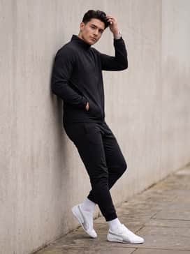 A monochromatic black athleisure set with slim-fit joggers to let the white and silver pop against the dark fabric.