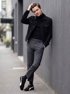 Cropped charcoal trousers with a tucked-in black turtleneck and a structured denim jacket for a smart-casual city vibe.