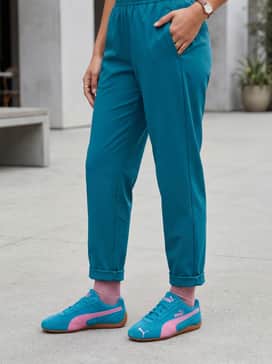 An oversized teal tracksuit set for a monochromatic look that allows the pink accents of the sneakers to pop.