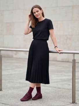 Combine with a pleated black midi skirt and a tucked-in vintage graphic tee to create a balanced contrast between feminine and sporty elements.