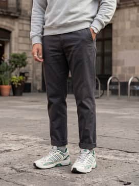 Spiritain 2000 Shoes – Black tapered tech-fleece joggers, a white moisture-wicking compression shirt, and an unzipped light grey windbreaker for a modern athletic look.