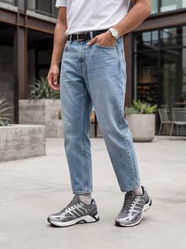 Style with light-wash relaxed-fit jeans, a crisp white graphic tee, and a navy blue nylon bomber jacket for a classic 90s-inspired aesthetic.