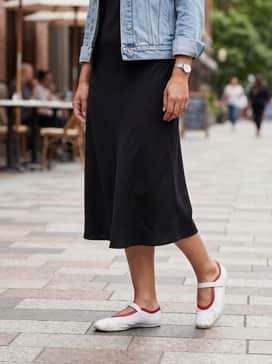 Style with a black midi-length slip dress and a light denim jacket for an effortless day-to-night urban look.