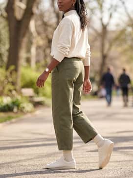 Stan Smith Lo Pro Shoes – Olive green utility-style cropped trousers with a tucked-in cream mock-neck sweater and gold hoop earrings to emphasize the shoe's clean lines.