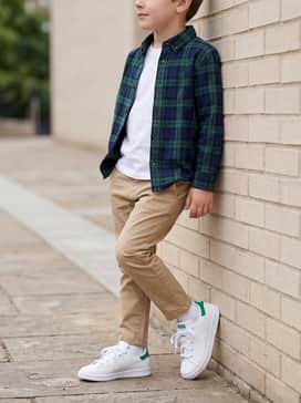 Khaki chino pants worn with a green and navy plaid button-down shirt for a smart-casual ensemble perfect for school photos or family gatherings.