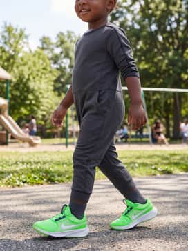 A dark charcoal athletic jumpsuit with moisture-wicking properties, ideal for high-activity days at the park.