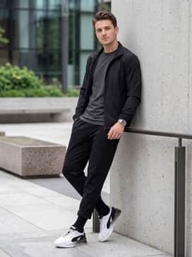 Monochrome black joggers and a matching technical windbreaker to lean into a sleek, athletic-inspired silhouette.