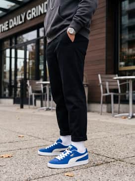 Style with black tapered joggers, a matching black oversized hoodie, and a silver chain necklace to create a high-contrast urban outfit.