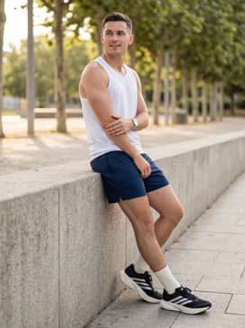 Deep navy 5-inch inseam athletic shorts, a breathable perforated white tank top, and high-performance quarter-length socks for a minimalist and functional summer training ensemble.