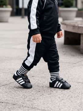 A matching black and white miniature tracksuit for a head-to-toe iconic athletic aesthetic.