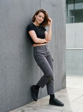 Wear with charcoal grey cargo pants, a black fitted crop top, and a silver chain necklace to embrace a modern, utilitarian streetwear aesthetic.