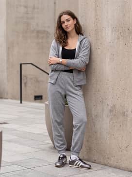 Taekwondo Lace Shoes – A matching heather grey jersey lounge set featuring tapered joggers and a zip-up hoodie over a sleek black bodysuit for an elevated off-duty vibe.