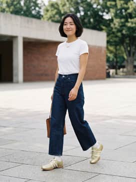 Pair these gold sneakers with high-waisted, wide-leg dark indigo denim and a tucked-in crisp white baby tee to let the metallic finish stand out.