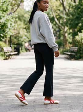 Classic black flare leggings paired with an oversized grey hoodie and a sleek ponytail for an effortless athleisure vibe.