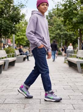 Terrascout – Straight-leg indigo jeans with a slight cuff, styled with a lavender oversized hoodie and a magenta knit beanie for a coordinated look.