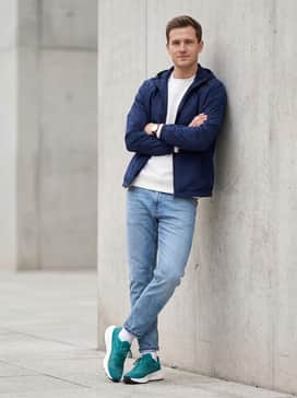 Terrex Agravic Speed Trail Running Shoes – A casual weekend ensemble with tapered light-wash athletic fit jeans, a navy blue windbreaker, and a simple white crewneck sweatshirt.