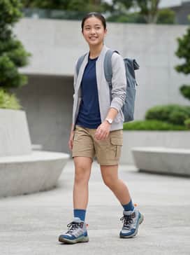 A pair of durable khaki cargo shorts paired with a moisture-wicking navy tech tee and high-cut athletic socks for a classic trail-ready look.