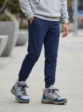 Terrex Ax4r Mid Hiking Shoes – Tapered black joggers and a grey fleece hoodie layered over a graphic t-shirt for a sporty and comfortable school outfit.