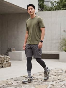Terrex Eastrail 3 Shoes – A technical hiking ensemble featuring moisture-wicking charcoal cargo shorts, a breathable olive green base layer tee, and high-performance wool socks in a matching grey tone.