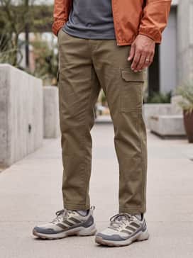 Terrex Eastrail 3 Shoes – A trendy gorpcore-inspired street look with loose-fitting khaki utility pants, an oversized graphic tee, and a lightweight waterproof shell jacket in a contrasting burnt orange.
