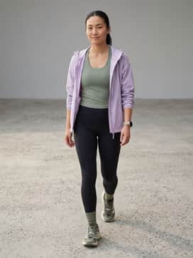 Terrex Freehiker Sl Goretex Hiking Shoes – High-waisted black compression leggings paired with a sage green moisture-wicking racerback tank and a lightweight lilac windbreaker to coordinate with the shoe's accents.