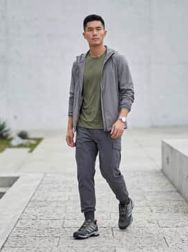 Terrex Skychaser Hiking Shoes – Tapered charcoal cargo pants paired with an olive green moisture-wicking performance tee and a lightweight grey windbreaker for a functional trail-ready look.