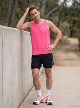 Terrex Skychaser X Shmoofoil Goretex Hiking Shoes – A performance-focused trail running ensemble with black athletic shorts, white compression socks, and a breathable neon pink tank top to echo the shoe's accents.
