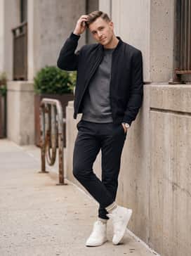 Black tailored joggers, a grey heathered hoodie, and a structured black bomber jacket for a modern streetwear vibe.