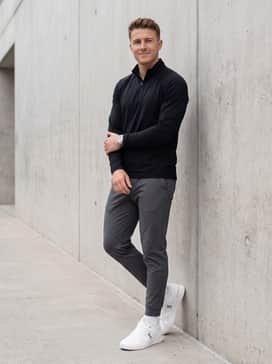 The Roger Clubhouse Pro – Tapered charcoal grey tech joggers and a moisture-wicking black quarter-zip pullover for a sleek, performance-ready ensemble.