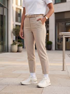 Tailored beige linen trousers and a tucked-in white heavyweight cotton tee, finished with a gold watch to mirror the shoe's accents.