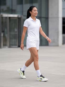 The Roger Pro Fire – Professional On-Court Look: A crisp white moisture-wicking polo paired with matching technical tennis shorts and high-performance white crew socks to make the lime green accents pop.