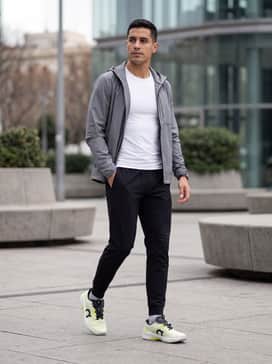 The Roger Pro Fire – Elevated Athleisure: Tapered black technical joggers, a minimalist white compression tee, and a lightweight grey windbreaker for a sleek, functional silhouette.