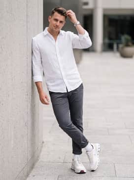Tapered charcoal chinos and a crisp white linen button-down for a smart-casual office environment.