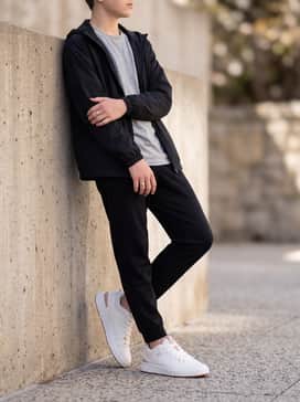Tapered black joggers worn with a graphic heather grey t-shirt and a lightweight windbreaker for a comfortable, sporty playground-ready outfit.