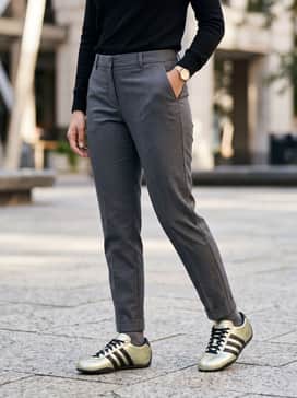 Charcoal grey tailored chinos with a tucked-in black turtleneck and a gold watch to complement the shoe's metallic finish for a smart-casual office vibe.
