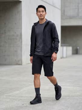 Trailcross Goretex Mountain Bike Shoes – A technical pairing featuring black padded mountain bike shorts, a moisture-wicking charcoal jersey, and a lightweight waterproof windbreaker for a performance-ready trail look.