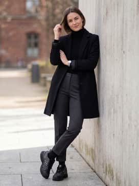 Slim-fit charcoal chinos with a tucked-in black turtleneck and a tailored wool overcoat for a sophisticated urban style.