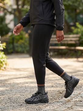 All-black athletic leggings worn with a cropped windbreaker and high-performance socks to lean into the shoe's sporty heritage.