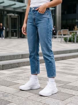 Ua Ace Low 2 – Mid-wash cropped straight-leg denim jeans with a tucked-in ribbed white tank top and a structured beige blazer for a clean, casual-smart aesthetic.