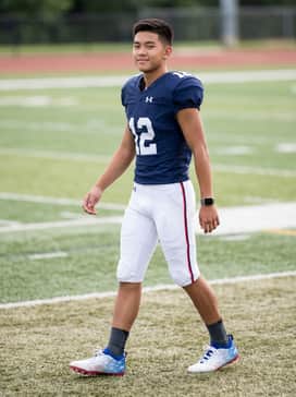 Ua Blur Select Jr Usa – A full team uniform featuring a navy blue jersey and white padded football pants to highlight the shoe's patriotic colors.