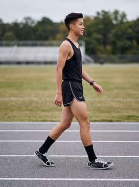 A professional racing kit featuring a slim-fit moisture-wicking singlet and matching high-cut split running shorts for maximum mobility.