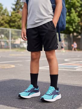 Ua Charged Ascend – Black mesh basketball shorts, a neon yellow graphic performance tee, and white mid-calf athletic socks.