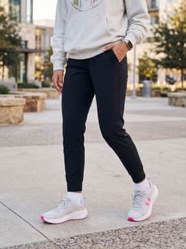 Black high-waisted leggings and an oversized light grey graphic hoodie for a comfortable and stylish school outfit.