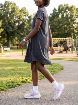 A charcoal grey jersey knit t-shirt dress and white ankle socks for a sporty and feminine everyday ensemble.