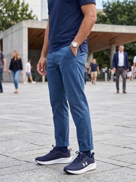 Casual streetwear ensemble consisting of slim-fit indigo denim, a crisp white oversized hoodie, and a matching navy baseball cap.
