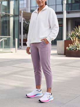 Ua Charged Chase – Dusty lilac 7/8 yoga pants and an oversized white quarter-zip pullover for a chic, comfortable studio-to-street transition.