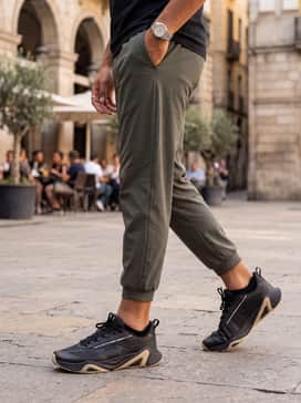 Ua Charged Commit Tr 5 – A relaxed weekend ensemble consisting of olive green cargo shorts, a sand-colored oversized graphic tee, and a matching tan baseball cap to tie in the shoe's accent colors.